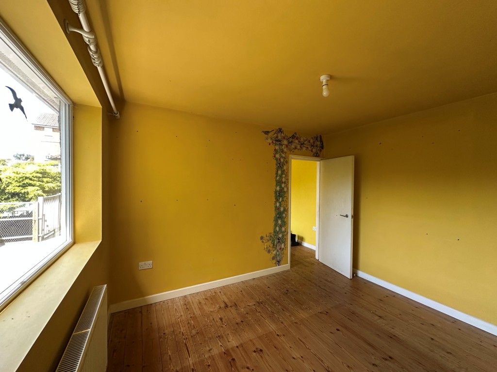 Lot: 125 - THREE-BEDROOM DETACHED HOUSE WITH POTENTIAL - Main Bedroom with window view over back garden
